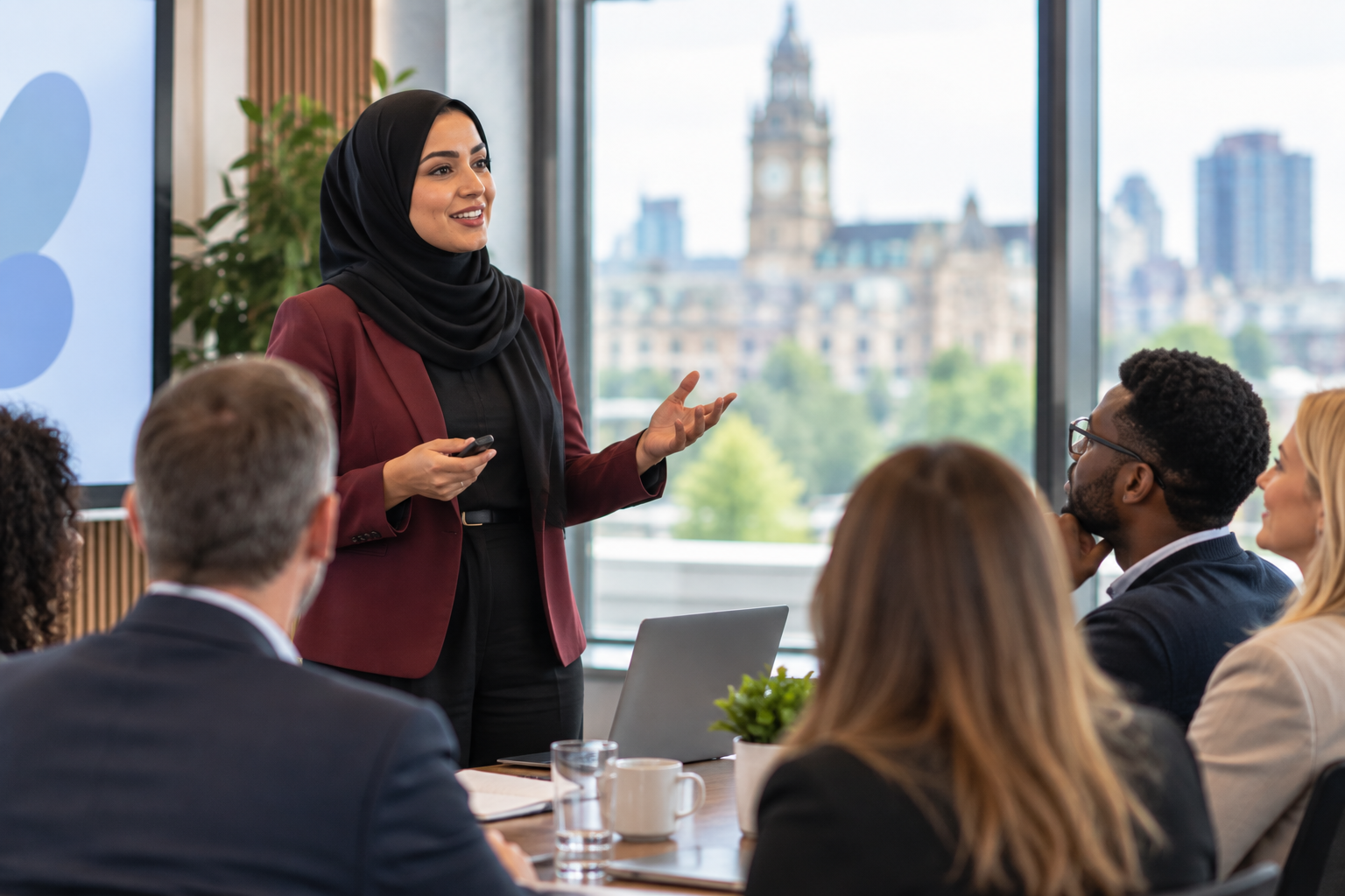 Muslim businesswoman presenting to a diverse group of professionals at a business networking meeting.